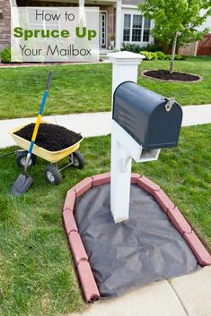 a mailbox and wheelbarrow in front of a suburban house stock photo - 957982