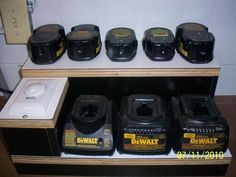 several different types of black and yellow jars are on a shelf next to a clock