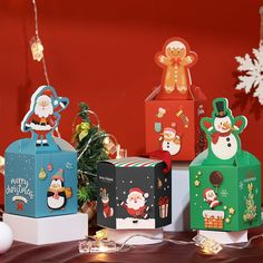 several boxes with christmas decorations on them sitting on a table