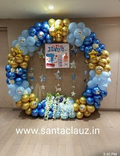 a blue and gold balloon arch with stars