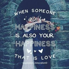 a man and woman standing next to each other in front of a stone wall with the words, when someone else's happiness is also your happiness that is love