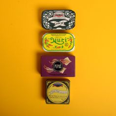 three different types of tins on a yellow background