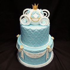 a blue and white cake with a crown on top