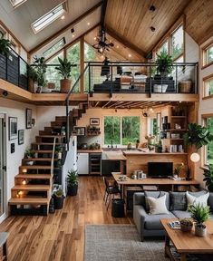 a living room filled with lots of furniture and wooden flooring next to a stair case