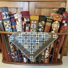 a basket filled with lots of different colored quilts