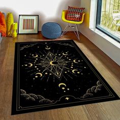 a black area rug with an image of the sun and moon on it in front of a window