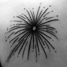 a black and white photo of a starburst tattoo on the back of a woman's shoulder