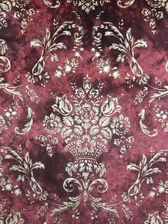 a red and white fabric with floral designs on the front, in shades of purple