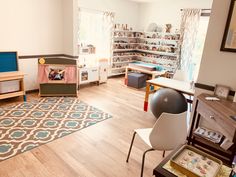 a child's playroom with toys and furniture