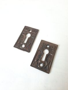 two antique iron door handles on a white background