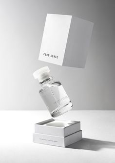 a white box with a bottle on top of it that is flying in the air