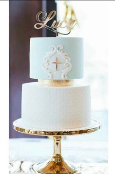 a white and gold wedding cake sitting on top of a table