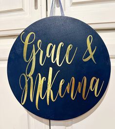 a blue and gold sign hanging from the side of a door that says grace & mikenna