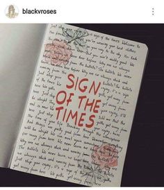 an open book with writing on it that says sign of the times in red ink