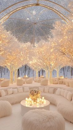 a living room filled with lots of white couches and tables covered in lights under a canopy