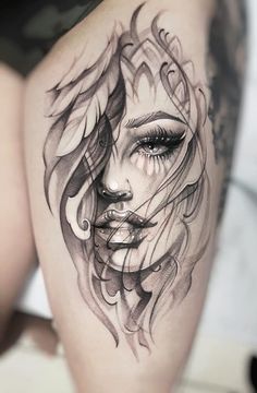 a woman's thigh with an artistic tattoo design on the thighs and her face