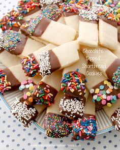 chocolate dipped shortbread cookies with sprinkles on a plate