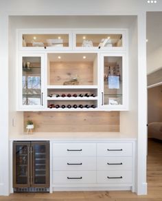 a kitchen with white cabinets and drawers