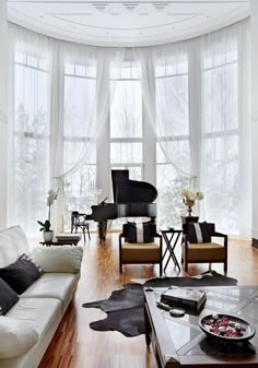 a living room filled with furniture and a piano