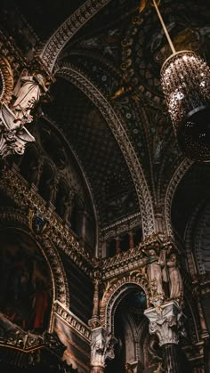 an ornate building with chandeliers hanging from the ceiling