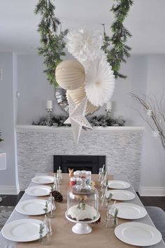 a dining room table is set with plates and place settings for the holiday dinner party