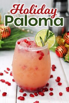 a holiday drink with pomegranate garnish on the rim