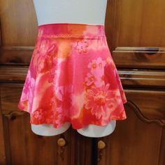 This pull on skirt is made from a coral, orange, pink Hawaiian print spandex.  XS size fits waist 25-27.  Hips 34-36 inches.  Front length 10 inches.  Back length 12 inches.  Free first class shipping within USA.  This print is also available in my shop in XXS, S and Med. Fitted Red Swim Skirt For Summer, Spring Multicolor Stretch Swim Skirt, Orange Floral Print Skirt, Orange Skirted Skort For Spring, Spring Orange Skirted Skort, Fitted Orange Skort, Fitted Floral Print Pink Bottoms, Fitted Short Orange Bottoms, Fitted Short Length Orange Bottoms