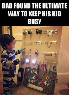 a little boy standing in front of a display with keys and lights on the wall