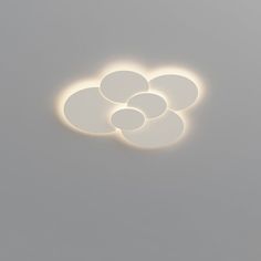 three circles are shown in the middle of a gray background with light coming from them