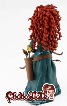 a doll with red hair is holding a flower pot