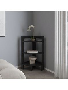 a corner shelf in the corner of a room with a flower pot on top of it