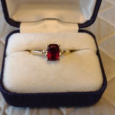 The Most Beautiful Deep Red Ruby In An Emerald Cut With A Diamond On Each Side, Set In 10k Gold. Crafted In Warm 10k Gold, This Ring Features A 7.0mm X 5.0mm Deep And Bright Red Ruby Center Stone In A Traditional Four-Prong Setting. This Gemstone Is Flanked By Two Dazzling Diamonds That Complement The Ruby And Add Extra Shimmer. This Is My Favorite Ring, It Is So Beautiful. It Just No Longer Fits Me. Emerald Cut Ruby Ring, Rectangle Engagement Rings, Jared Jewelry, Silver Ruby Ring, Red Ruby, Ruby Ring, Favorite Rings, 10k Gold, Womens Jewelry Rings