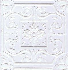 a white tile with an intricate design on it