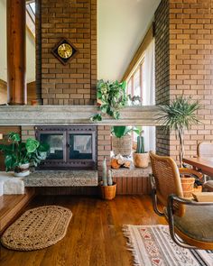 a living room filled with furniture and a fire place next to a clock on the wall