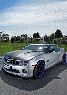 a silver sports car parked in a parking lot