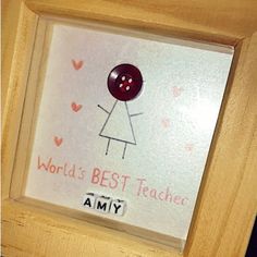 a wooden frame with a button on it that says, world's best teacher