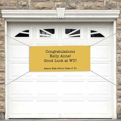 a white garage door with a yellow sign in front of it that says congratulations kelly annne good luck at wj