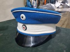 a blue and white hat sitting on top of a table