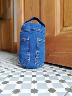 a denim bag sitting on the floor next to a door