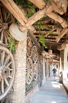 an old building with wooden wheels hanging from the ceiling