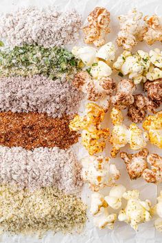 several different types of popcorn on top of each other with sprinkles and seasoning