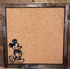 a cork board with a drawing of mickey mouse on it