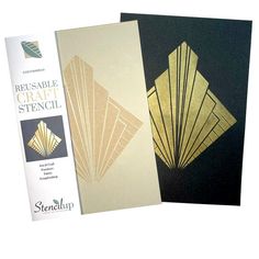 two cards with gold foil on them, one is folded and the other has a black background