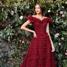 This Dramatic Tulle Dress Is Decorated With Ruffles Over A Pleated Bodice With A Corset Structure, Also The Skirt With Ruffles Has A Small Train And The Waist Is Decorated With Beaded Belts That Complete The Graceful Image. Fabric: Tulle Length: Long Colour: Burgundy Neckline: Off The Shoulder Silhouette: A-Line Sleeve: Sleeveless Back: Zipper Skirt: Train Embellishments: Beads Occasion: Romantic Date/Evening/Dinner, Wedding/Bridesmaid, Graduation, Fashion Show, Visiting Theater/Museum/Restauran Burgundy Sleeveless Gala Dress, Burgundy Sleeveless Dress For Gala, Sleeveless Burgundy Dress For Gala, Red Sleeveless Tulle Dress, Sleeveless Red Tulle Dress, Burgundy Sleeveless Evening Dress, Red Sleeveless Evening Dress With Ruffles, Burgundy Sleeveless Ruffled Dress, Burgundy Sleeveless Dress With Ruffles