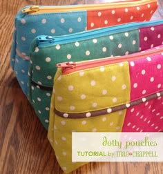 three colorful polka dot bags sitting on top of a wooden floor next to each other