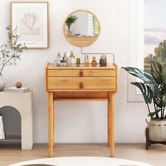 a wooden table topped with lots of bottles next to a mirror and potted plant