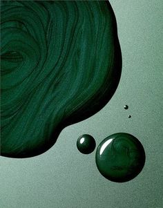 two drops of green liquid sitting next to each other