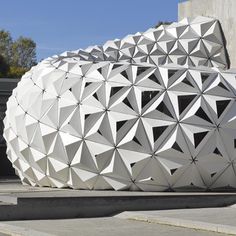 a large white object sitting on the side of a road in front of a building