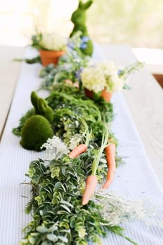 some carrots and other vegetables are lined up on a table