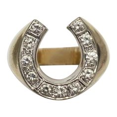 a silver and gold ring with diamonds in the middle, set on top of a white background